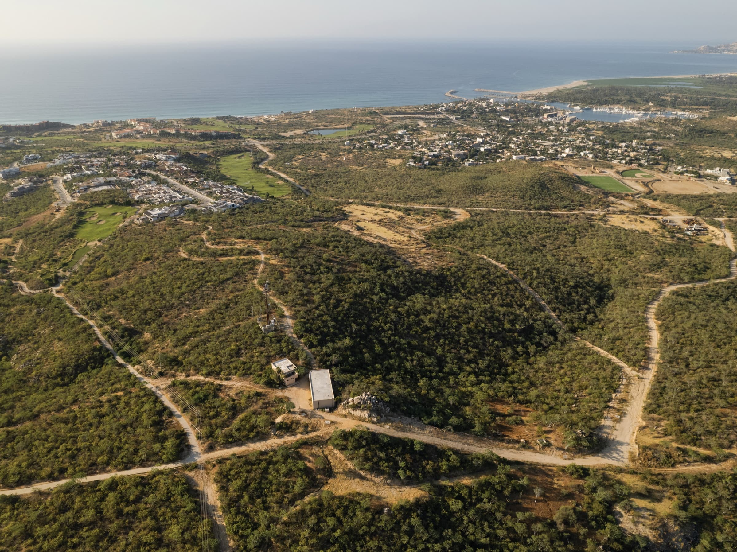 Aerial view of the Vitality Grove site inside Puerto Los Cabos with the marina and Sea of Cortez beyond